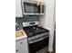 Modern kitchen features stainless steel appliances and an eye-catching patterned backsplash at 5925 Terrace Park N Dr # 210, St Petersburg, FL 33709