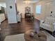 Spacious living area leading to dining area, showcasing dark wood floors and ample lighting at 5925 Terrace Park N Dr # 210, St Petersburg, FL 33709