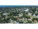 An aerial shot showcases a cozy home in a lush, tree-lined neighborhood with a view of the bay at 5998 8Th S St, St Petersburg, FL 33705