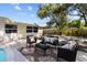 The backyard has an outdoor seating area that overlooks the pool and surrounding green landscape at 5998 8Th S St, St Petersburg, FL 33705