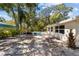 Spacious backyard featuring a pool, outdoor seating, and mature trees at 5998 8Th S St, St Petersburg, FL 33705