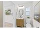Well-lit bathroom showcases a modern vanity with a unique mirror and a sleek toilet at 5998 8Th S St, St Petersburg, FL 33705