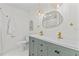 Bright bathroom featuring a double sink vanity, modern fixtures, and decorative mirror and lighting at 5998 8Th S St, St Petersburg, FL 33705