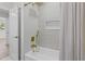 Modern bathroom featuring white tile in the shower and gold fixtures at 5998 8Th S St, St Petersburg, FL 33705