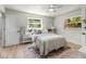 Bright bedroom featuring a ceiling fan, comfortable bed, and natural light from two windows at 5998 8Th S St, St Petersburg, FL 33705