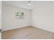 Inviting bedroom with a ceiling fan, hardwood floors, and a large window offering plenty of light at 5998 8Th S St, St Petersburg, FL 33705