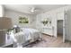 Cozy bedroom with a ceiling fan, large window, and comfortable bed offers a relaxing retreat at 5998 8Th S St, St Petersburg, FL 33705