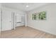 Bedroom with light wood flooring, a window and a closet with built in shelving at 5998 8Th S St, St Petersburg, FL 33705