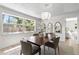 Bright dining room features a wood table, four chairs, decorative mirrors and a modern lighting fixture at 5998 8Th S St, St Petersburg, FL 33705