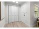 Entryway featuring light wood floors, closet, and neutral paint creating a welcoming atmosphere at 5998 8Th S St, St Petersburg, FL 33705