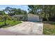 Charming single-story home featuring a well-manicured lawn and a driveway leading to an attached garage at 5998 8Th S St, St Petersburg, FL 33705