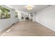 Open-concept living room with lots of natural light showcases beautiful floors that lead into the dining area at 5998 8Th S St, St Petersburg, FL 33705