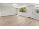 Bright living room offers natural light and features new flooring and white walls at 5998 8Th S St, St Petersburg, FL 33705