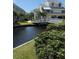 Scenic pond view with a charming bridge connecting the community and lush green landscape at 6932 Stones Throw N Cir # 7101, St Petersburg, FL 33710