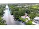 Stunning aerial view of the home nestled on the river, surrounded by lush greenery and beautiful landscaping at 8001 N Highland Ave, Tampa, FL 33604