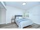 Calm bedroom featuring a comfortable bed with a blue striped pattern and soft lighting at 8001 N Highland Ave, Tampa, FL 33604