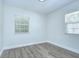 Bright bedroom with light walls, a window, and wood floors at 8001 N Highland Ave, Tampa, FL 33604