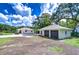 Exterior shot of a property featuring a two-car garage and ample parking space at 8001 N Highland Ave, Tampa, FL 33604