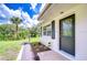 Inviting front entrance with decorative door, beautiful new landscaping, and a view of the water at 8001 N Highland Ave, Tampa, FL 33604