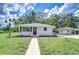 Charming single-story home with a well-manicured lawn, new landscaping, and a detached garage at 8001 N Highland Ave, Tampa, FL 33604