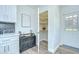 Bright kitchen with white cabinets, modern appliances, a pantry, and new flooring at 8001 N Highland Ave, Tampa, FL 33604