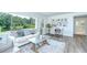 Bright living room with a stunning lake view from the large picture window at 8001 N Highland Ave, Tampa, FL 33604