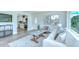 Bright living room featuring hard-surface floors, a comfortable white couch and modern decor at 8001 N Highland Ave, Tampa, FL 33604