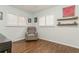 Well-lit room with hardwood floors, white shutters, and light green walls at 8014 27Th N Ave, St Petersburg, FL 33710