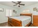 Bedroom features a wood-framed bed, plantation shutters and hardwood floors at 8014 27Th N Ave, St Petersburg, FL 33710
