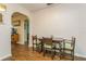 Cozy dining area with hardwood floors, a wooden table with chairs and arched entryway at 8014 27Th N Ave, St Petersburg, FL 33710