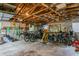 Spacious garage interior featuring exposed wood beams, tools, bikes, and ample storage space at 8014 27Th N Ave, St Petersburg, FL 33710