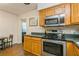 Galley style kitchen with wooden cabinets and stainless steel appliances at 8014 27Th N Ave, St Petersburg, FL 33710
