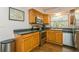 Bright kitchen with stainless steel appliances, wooden cabinets, and dark countertops at 8014 27Th N Ave, St Petersburg, FL 33710