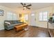 Bright living room with hardwood floors and white plantation shutters on the windows at 8014 27Th N Ave, St Petersburg, FL 33710