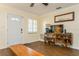 Living room with hardwood floors, white door and shutters, showcasing a cozy ambiance at 8014 27Th N Ave, St Petersburg, FL 33710