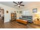 Living room featuring hardwood floors, modern ceiling fan, and bright window with shutters at 8014 27Th N Ave, St Petersburg, FL 33710