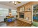Bright living room features brick fireplace, wood floors and a convenient doorway to another room at 8014 27Th N Ave, St Petersburg, FL 33710