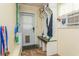 Mud room featuring a convenient bench and storage, an AC unit and an exterior entrance at 8014 27Th N Ave, St Petersburg, FL 33710