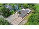 An aerial view shows the home's layout and spacious gravel driveway, with surrounding trees at 8105 N Grady Ave, Tampa, FL 33614