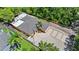 Aerial view of the property highlighting the home's layout, driveway, and surrounding landscape at 8105 N Grady Ave, Tampa, FL 33614