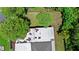 Aerial view of the backyard and roof of the house with trees around the property at 8105 N Grady Ave, Tampa, FL 33614