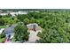 An aerial shot of the home showcasing the surrounding neighborhood and ample tree coverage at 8105 N Grady Ave, Tampa, FL 33614