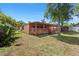 Inviting covered deck with a wooden railing overlooking the large backyard at 8105 N Grady Ave, Tampa, FL 33614