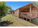 View of the large covered deck with outdoor seating and a well-maintained backyard lawn at 8105 N Grady Ave, Tampa, FL 33614