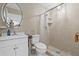 Cozy bathroom with a shower, patterned tile floors, vanity sink, and a neutral, earth-toned color scheme at 8105 N Grady Ave, Tampa, FL 33614