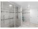 Modern bathroom featuring a glass-door shower with tiled walls and floors at 8105 N Grady Ave, Tampa, FL 33614
