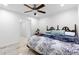 Bright bedroom with a ceiling fan, light-colored tile floors, and an antique headboard at 8105 N Grady Ave, Tampa, FL 33614