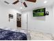 Bright bedroom with a ceiling fan, a TV, and a doorway to another room at 8105 N Grady Ave, Tampa, FL 33614