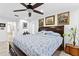 Comfortable bedroom featuring a ceiling fan, a large painting, and neutral decor at 8105 N Grady Ave, Tampa, FL 33614