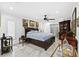 Well-lit bedroom with a ceiling fan, marble floors, and stylish furnishings at 8105 N Grady Ave, Tampa, FL 33614